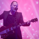 Thom Yorke, suspended in jello, slowly prepares to play a chord.